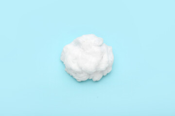 Soft cotton wool on blue background
