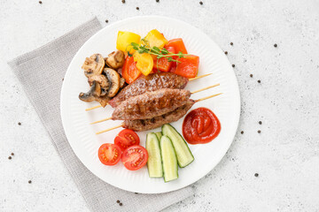 Plate of skewers with tasty lula kebab and vegetables on light background