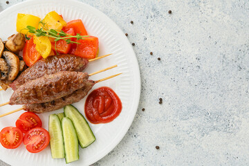 Plate of skewers with tasty lula kebab and vegetables on light background, closeup