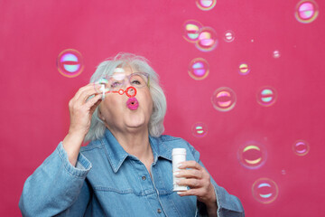 older woman make bubbles