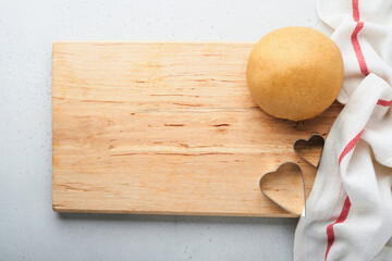 Baking ingredients and kitchen utensils on a white background top view. Preparing heart sugar cookies. Baking background. Flour, eggs, sugar, spices, and a whisk on the kitchen table. Flat lay.