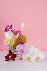 spa set in trolley on pink background, self care concept, womens day 