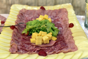 delicious sliced ​​cheese with salami ham and salad, party buffet