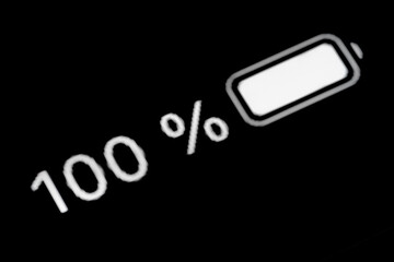 Smartphone full charged battery level indicator - one hundred, 100 percent: close up macro view of...