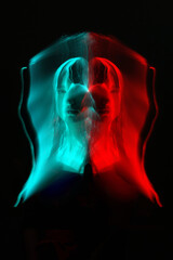 Abstract woman silhouette portrait in bright light trails of light painting in RGB split style of red and blue colors. Long exposure photo. Image contains noise and motion blur
