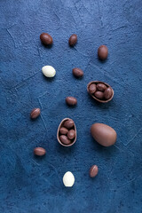 Composition with chocolate Easter eggs on dark background
