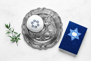 Passover Seder plate, Torah and kippah on light background