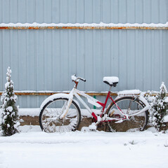 Old rusty bicycle covered with snow