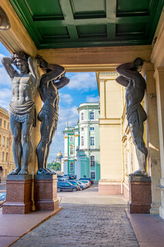 Portico of New Hermitage building with Atlantes and St. Isaac's Cathedral at background in Saint Petersburg, Russia