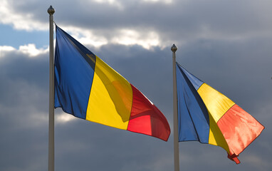 Flag of Romania winding against a spectacular cloudy blue sky