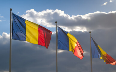 Flag of Romania winding against a spectacular cloudy blue sky