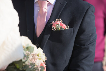 bride and groom with bouquet buttonhole flowers