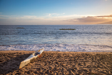 Beach in Maui with outrigger going across the water