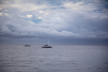 Boat on the ocean with stormy clouds
