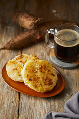 Tortilla de yuca a traditional Ecuadorian appetizer served with coffee. It’s on a wooden background.