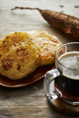 Tortilla de yuca a traditional Ecuadorian appetizer served with coffee. It’s on a wooden background.