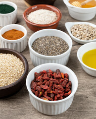 Assorted superfoods in over stone background. Chia, quinoa, oat, linseed, honey, spirulina and others