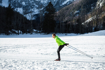 Male practicing skiing as a sport and recreational activity, elements of skate cross country technique.