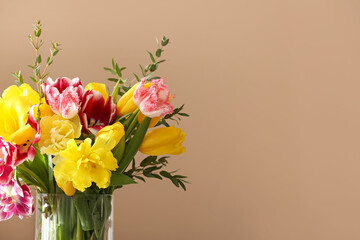 Fototapeta premium Vase with tulips and eucalyptus branches on beige background, closeup
