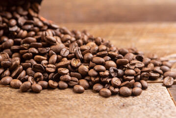 Fototapeta na wymiar coffee beans on wood background