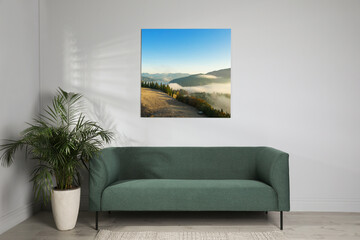 Canvas with printed photo of mountain landscape on white wall in living room