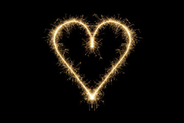 Fototapeta premium Heart shape made of sparks. Valentine's day love symbol, bright heart on black background