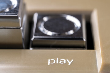 Pressed play button of a vintage tape recorder macro