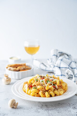 Roasted chicken mushroom pepper pasta in a white plate