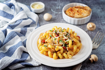 Roasted chicken mushroom pepper pasta in a white plate