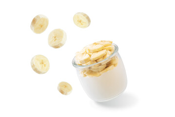 Greek yogurt with banana slices in a glass on a white isolated background
