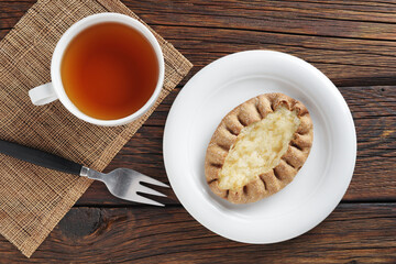 Bun with rice pudding and tea cup
