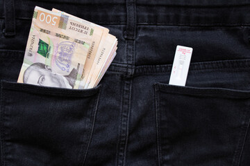 covid test lies on Ukrainian money lie on jeans, test