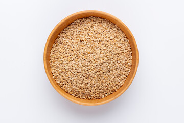 Bio natural sesame seeds on wooden bowl.