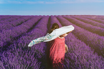 plus size woman from back in a lavender field.