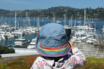 A girl looking at the sailboats