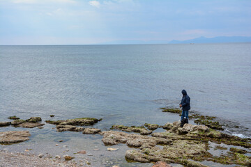 Fototapeta na wymiar man watching the sea on the rocks