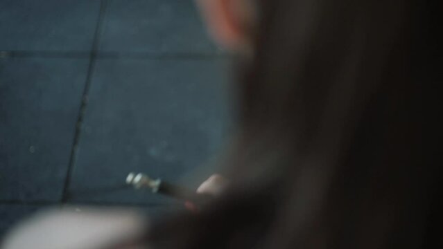 young spanish woman holding a camber with her hands at the training
