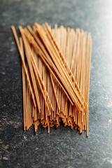 Uncooked whole grain spaghetti. Raw pasta on kitchen table.
