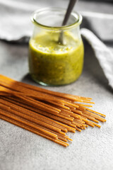 Uncooked whole grain spaghetti. Raw pasta on kitchen table.