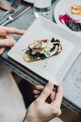 Crostini appetizer amuse bouche with mushrooms, nettle pesto, fennel