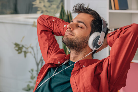 man at home resting listening to music relaxed