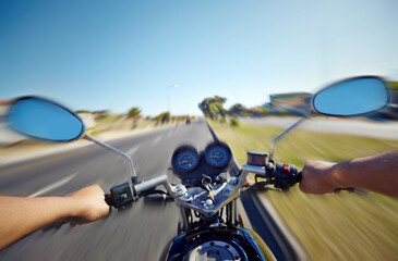 Cruising down the highway. POV shot of a person riding a motorcycle.