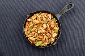chicken fried rice with vegetables in pan