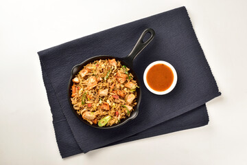 chicken fried rice served with chilli sauce on kitchen cloth