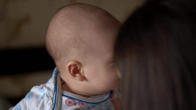 Newborn Baby With Young Mom look Into Each Other Eye. Cute Smiling Teethless Kid Face Portrait. Woman Kissing With Child Look At Camera. Infant, Mother Day, Childbirth, Beginning, Relationship Concept