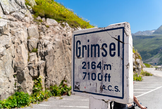 Grimselpass, Switzerland - August 13, 2021: The signpost at Grimsel Pass, a mountain pass in Switzerland, crossing the Bernese Alps at an elevation of 2164 metres.