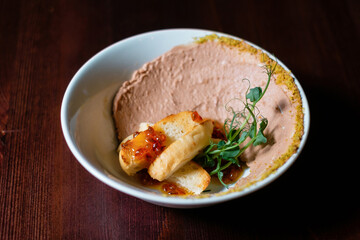 Pate with croutons and caviar side view. Restaurant menu design concept.