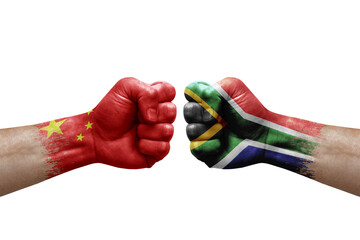 Two hands punch to each others on white background. Country flags painted fists, conflict crisis concept between china and south africa