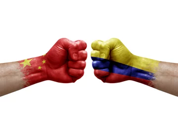 Foto op Canvas Two hands punch to each others on white background. Country flags painted fists, conflict crisis concept between china and colombia © prehistorik