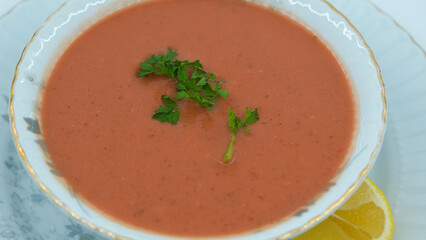 Red vegetable soup with parsley, macro